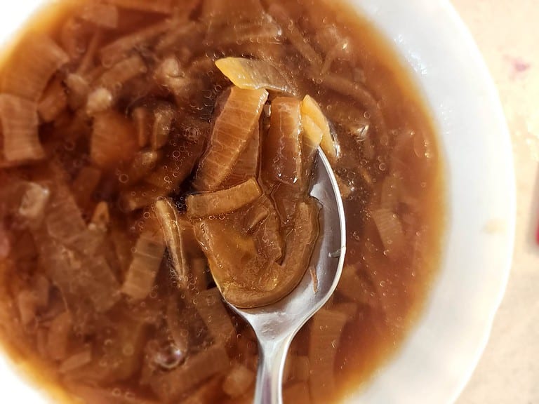 French onion soup in a bowl with a spoon