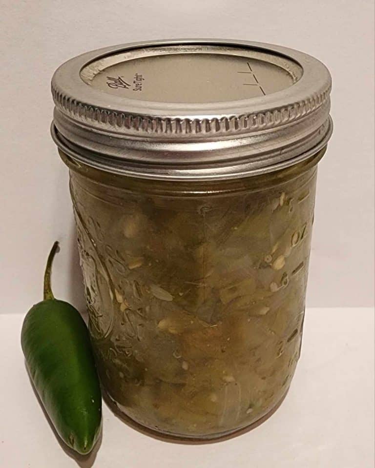 Jar of jalapeno relish with a jalapeno