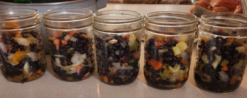 solids added to the jars of black bean soup