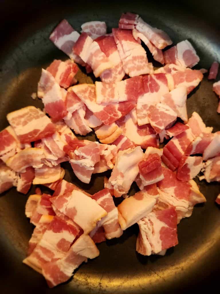 Bacon cooking in pan for loaded potato soup canning recipe