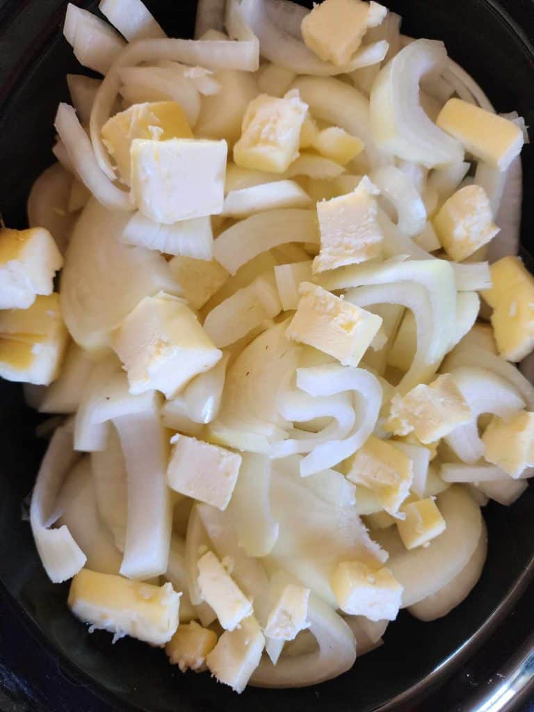 Sliced Onions in crockpot added butter for canning caramelized onions.