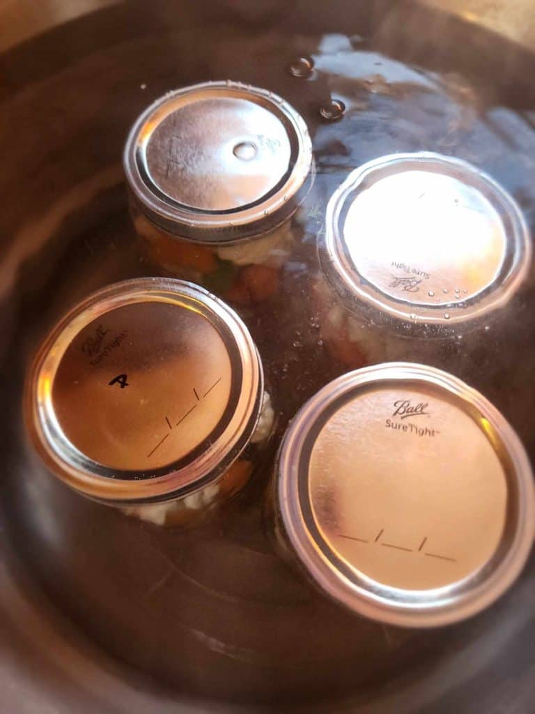 4 quart jars of pickled giardiniera added to the water bath canner