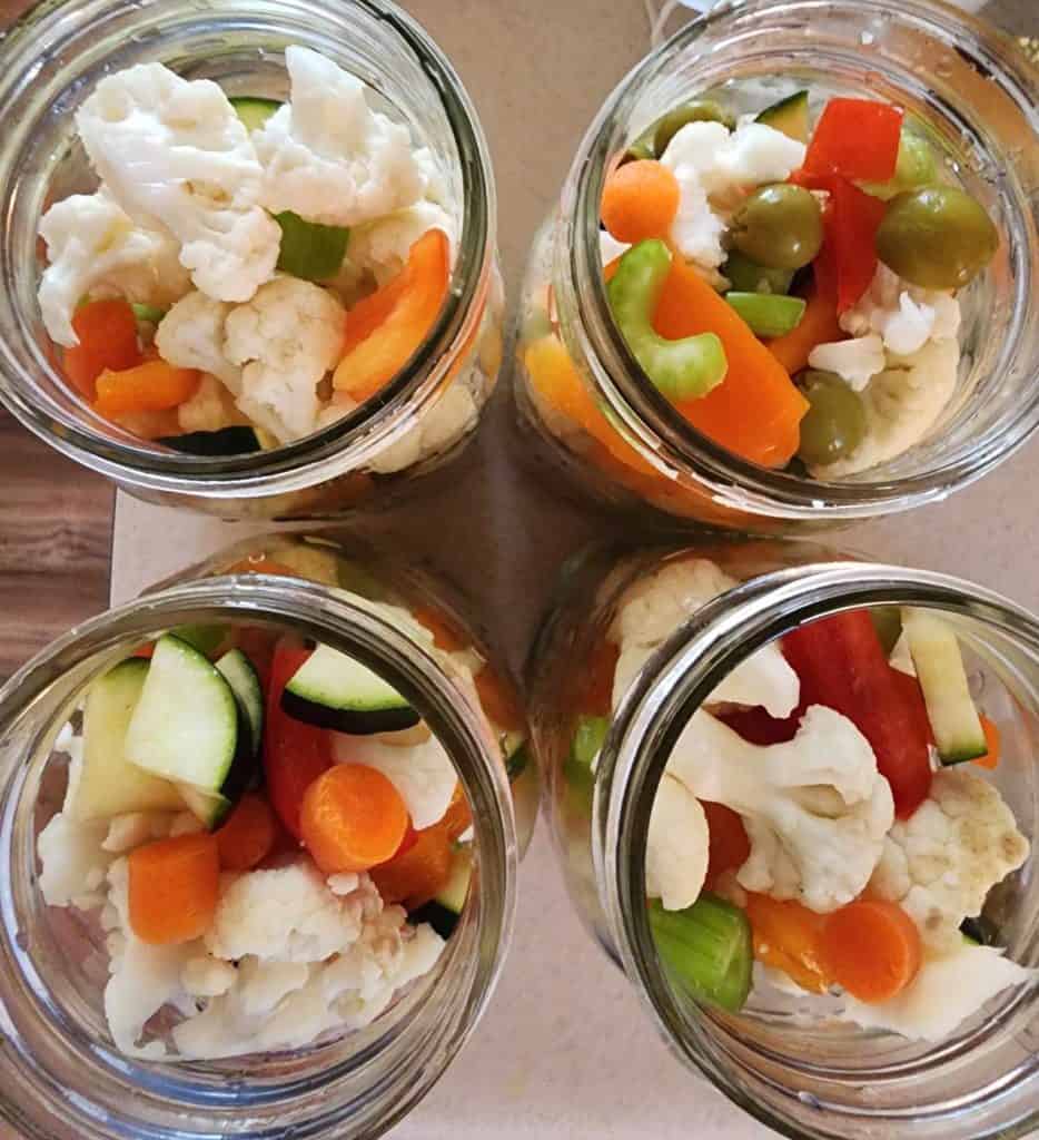 tops of canning jars with mixed vegetables for making canned giardiniera