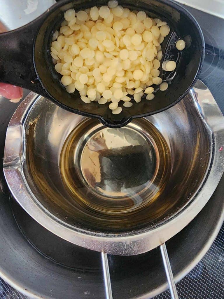 Adding beeswax to rosemary infused oil to make rosemary lotion bars