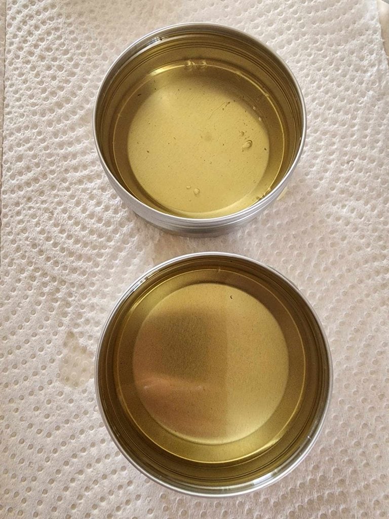 rosemary infused oil mixture poured into tins to harden into rosemary salve
