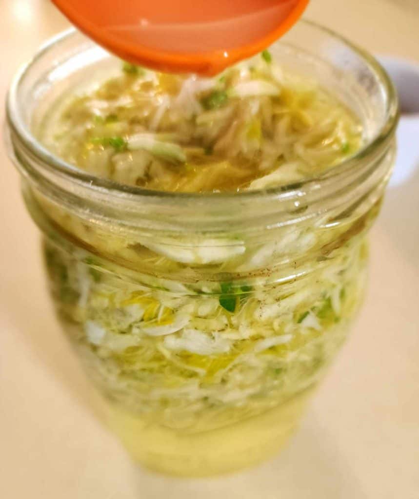 adding lemon juice to make the honeysuckle jelly