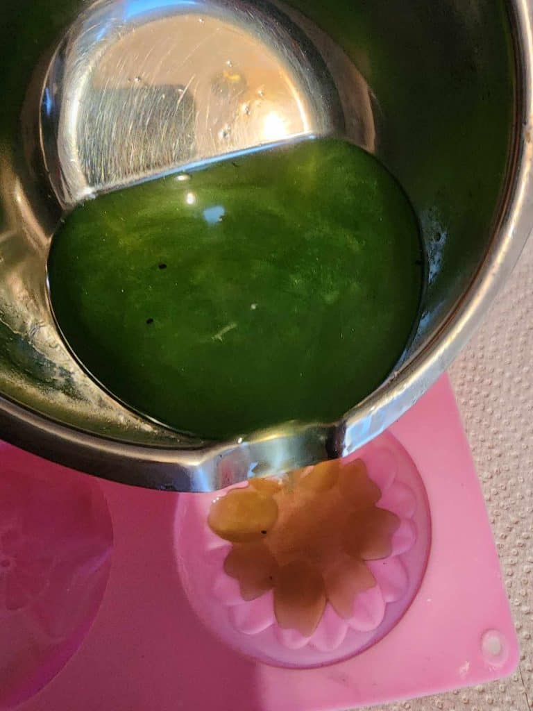 pouring catnip lotion bar solution into molds