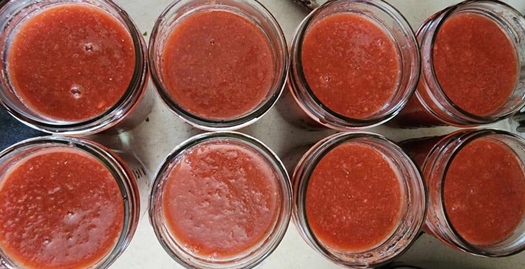 tops of jars of strawberry jalapeno bourbon bbq sauce
