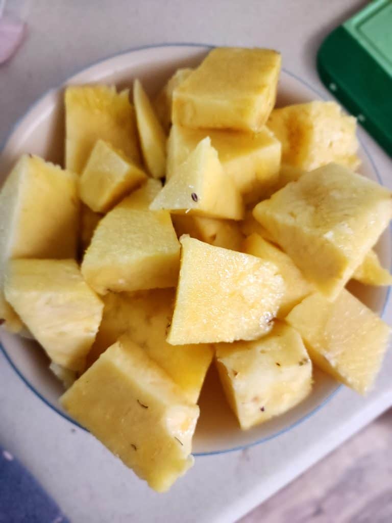 cut up pineapple in a bowl for pineapple jalapeno bourbon BBQ sauce