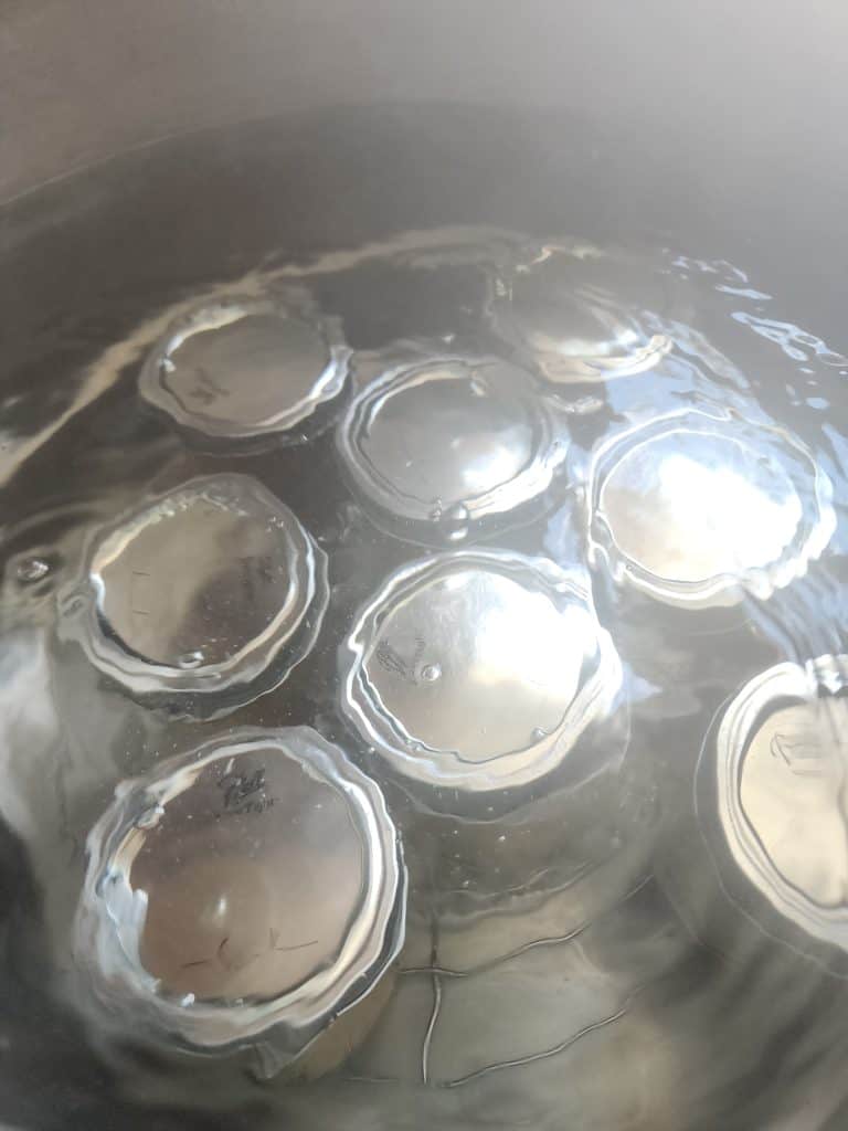 Jars of pineapple jalapeno bourbon bbq sauce in the canner