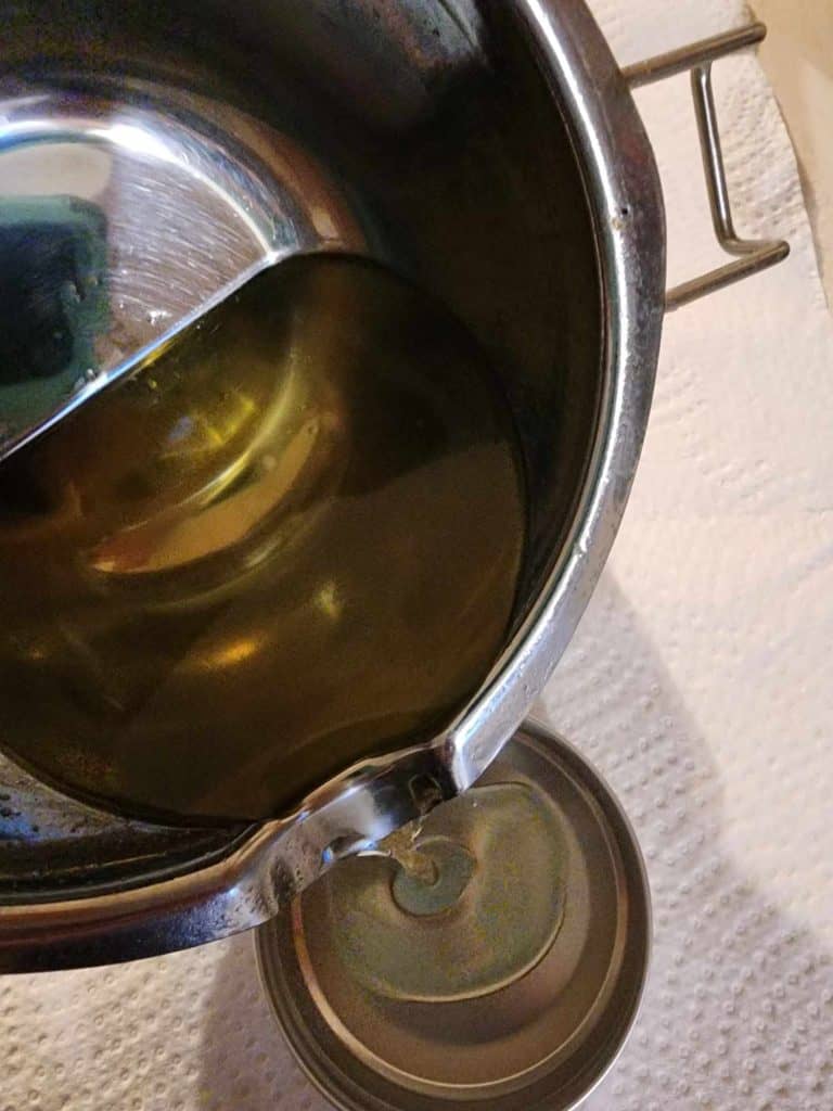 Pouring the plantain salve into the tins