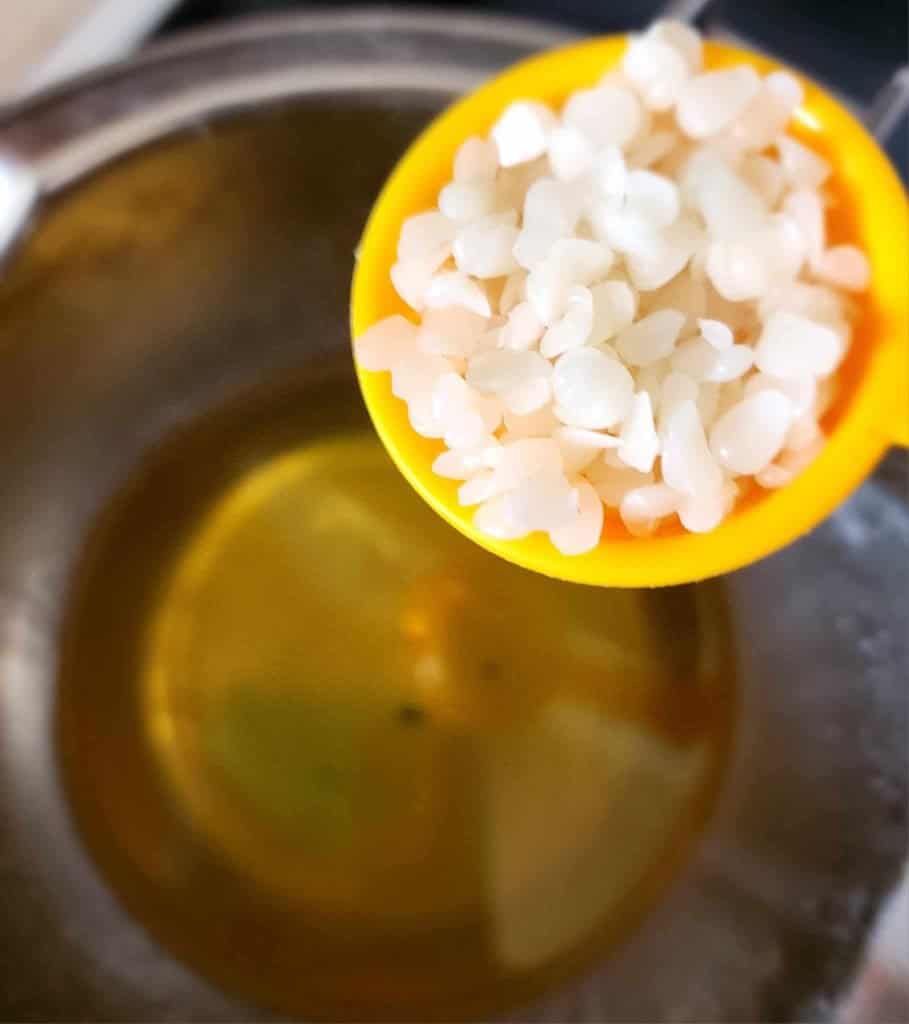 Adding beeswax to make calendula and plantain infused oil
