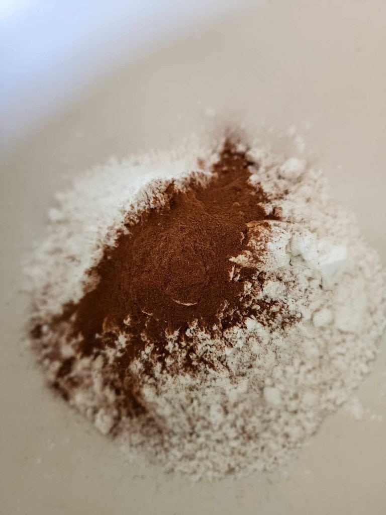 flour, baking power, baking soda and cinnamon to a bowl for apple bread