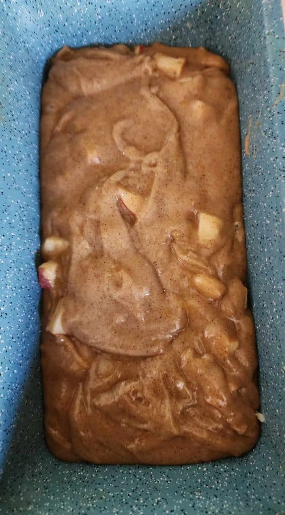 Apple bread mix added to a greased loaf pan