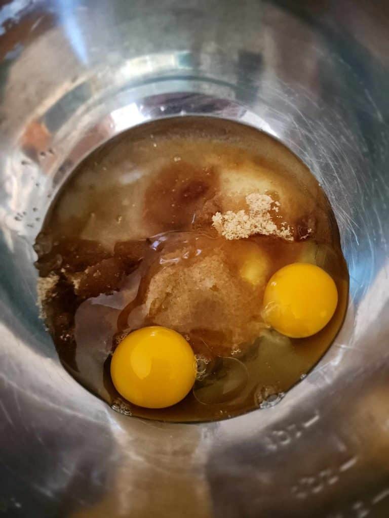 add the following ingredients the oil, sugars and eggs to a bowl to make apple bread