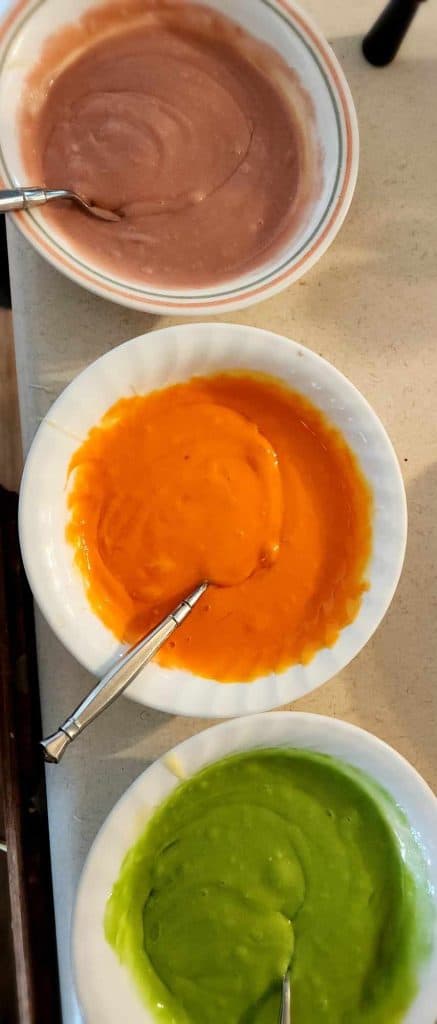 white cake mix divided into 3 colors
