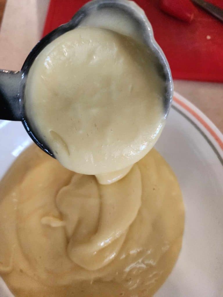 Measuring the cake mix into 3 separate bowls