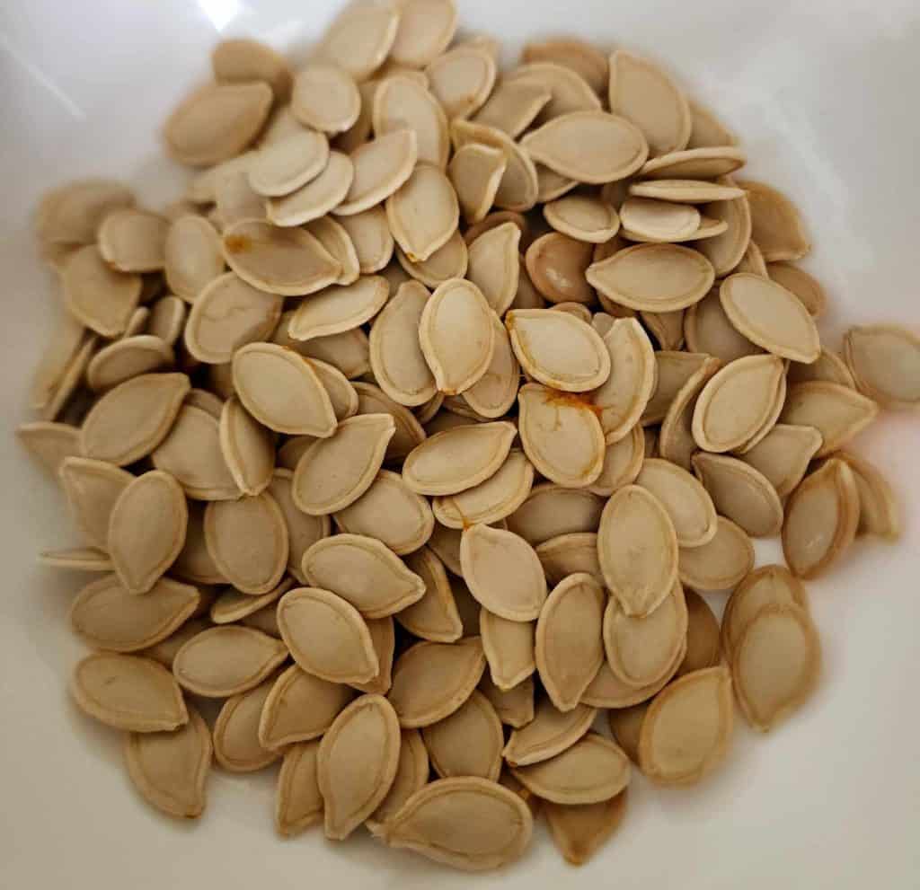 1 cup pumpkin seeds added to bowl to make roasted pumpkin seeds