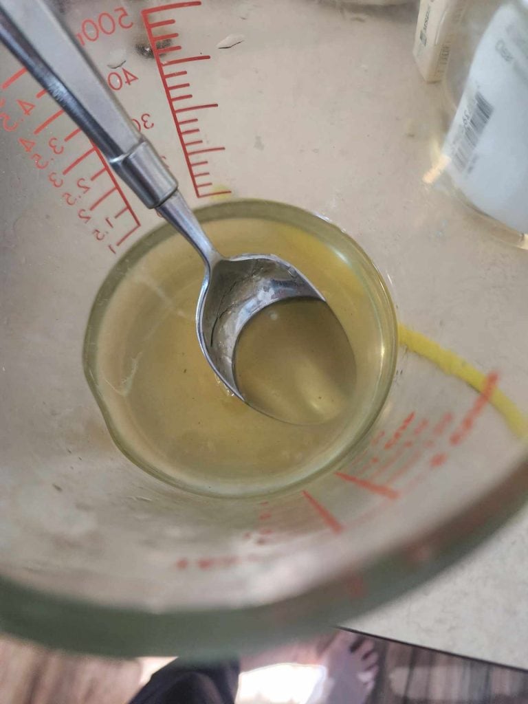 stirring the lip balm mixture after heating