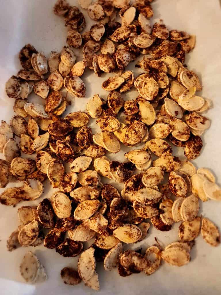 Sweet and salty pumpkin seeds on pan before roasting