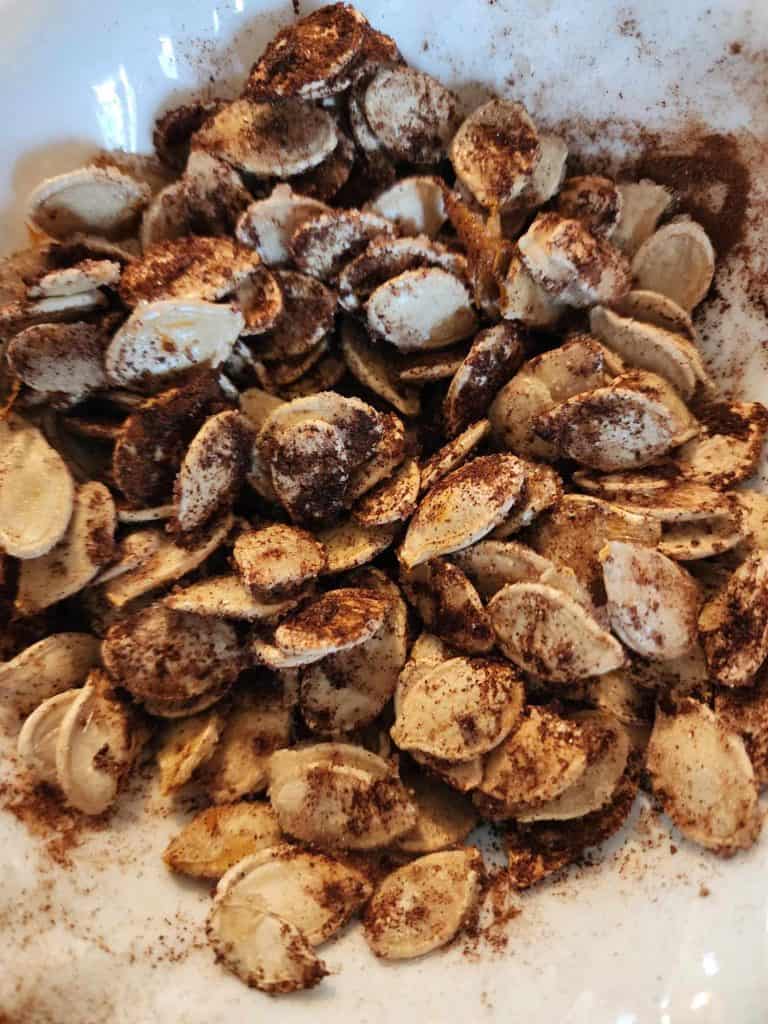 Sweet and salty pumpkin seeds in bowl before roasting