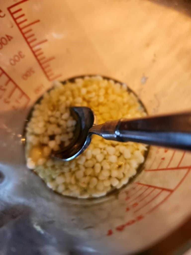 Stirring the melting ingredients for calendula lip balm