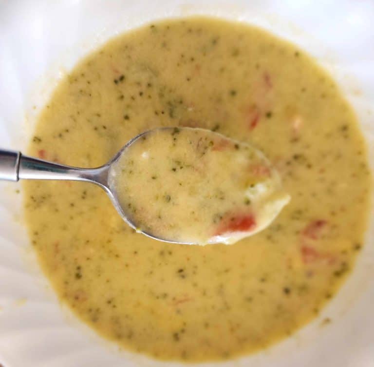 broccoli cauliflower cheese soup with rotel in bowl with a spoon
