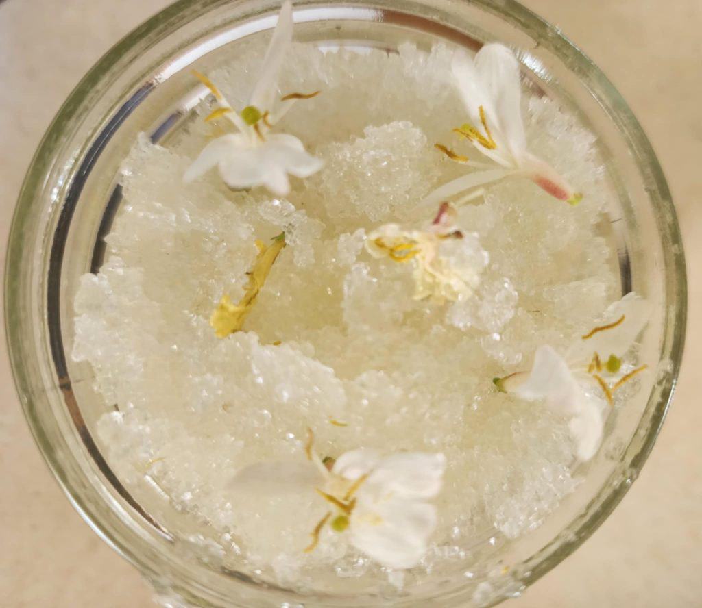 honeysuckle salt scrub with flowers from top of jar
