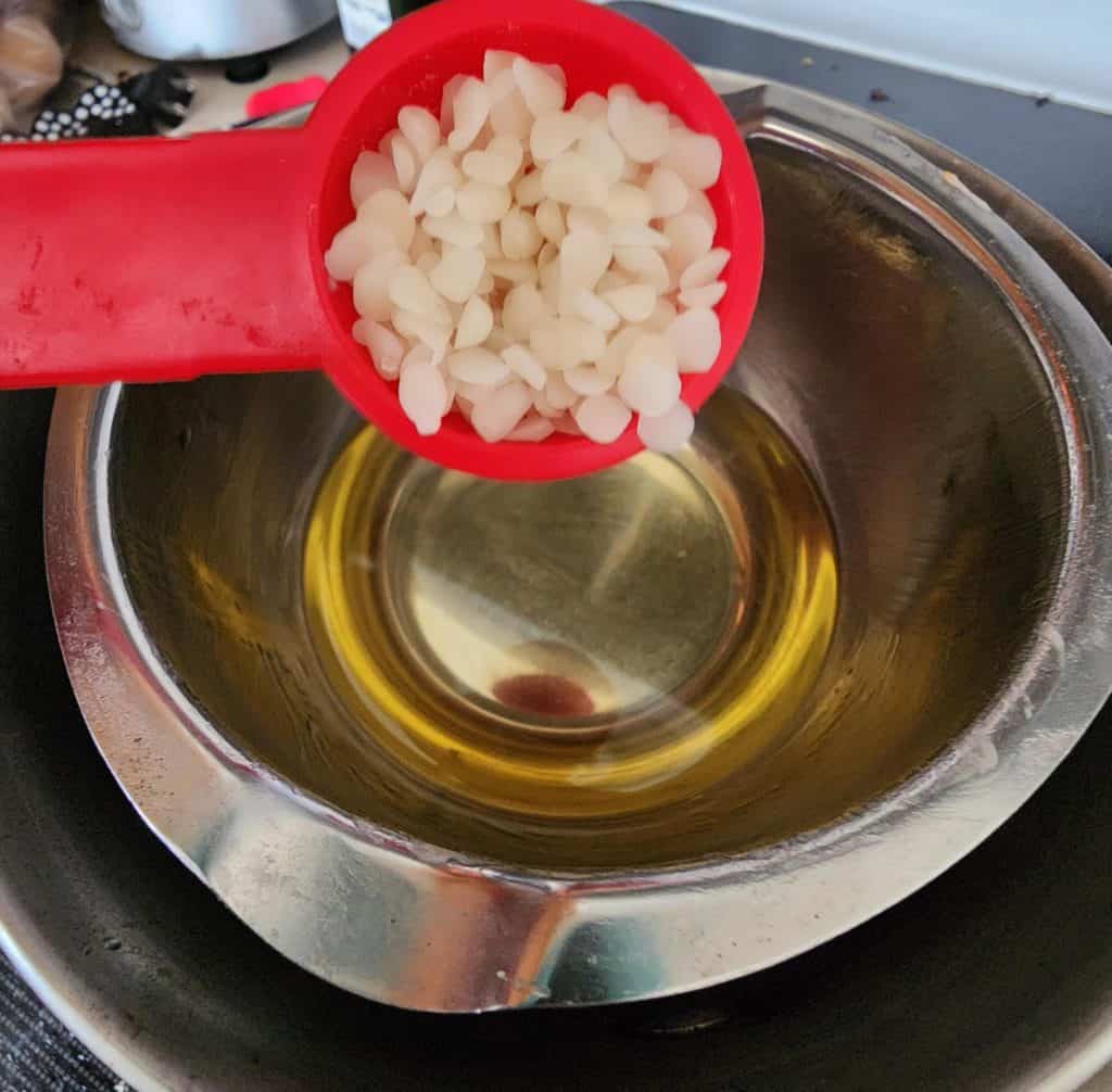Adding beeswax to the rose infused oil to make rose salve
