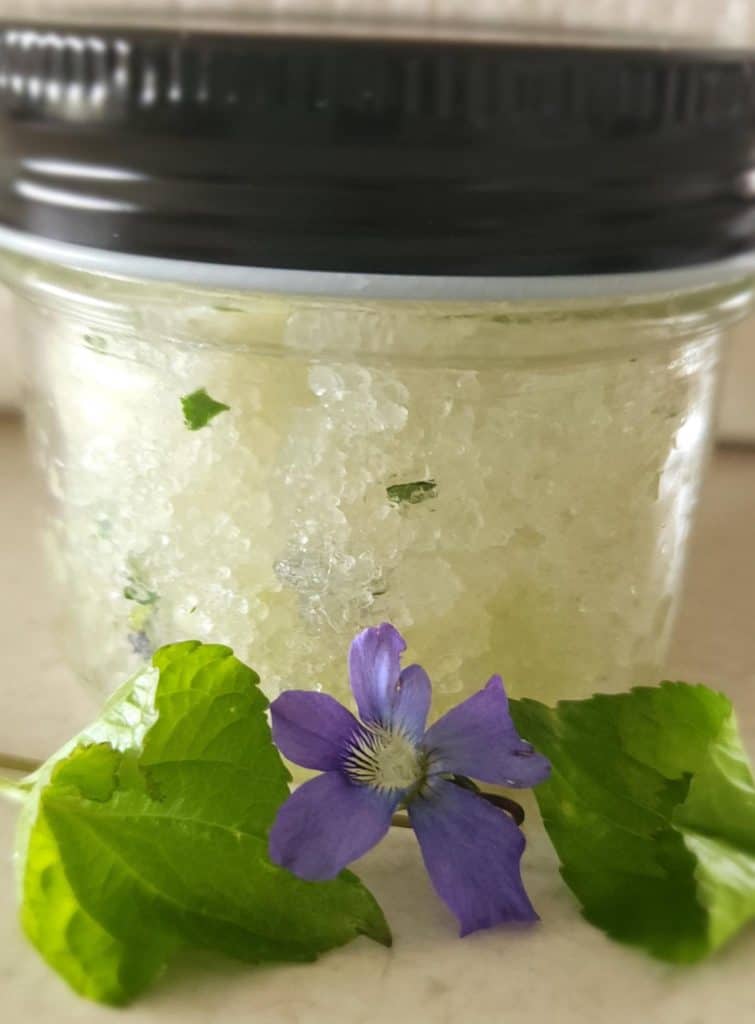 violet salt scrub with flowers and leaves