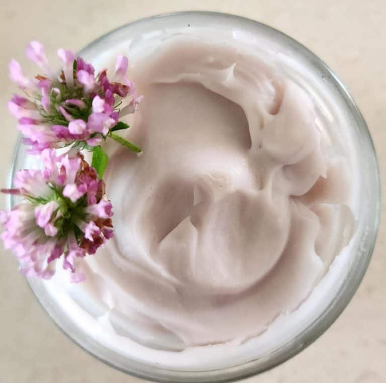 red clover whipped body butter in a jar with clover flowers