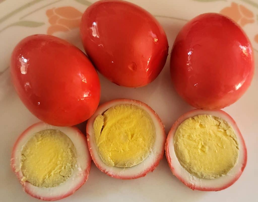 Bloody Mary pickled eggs with sliced eggs