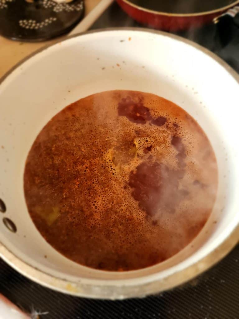 Heating and stirring ingredients for brine for Bloody Mary Pickled Eggs