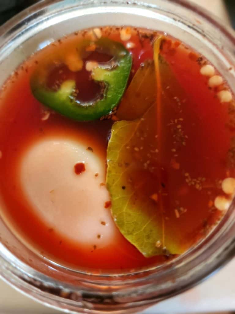 top of jar of Bloody Mary pickled eggs
