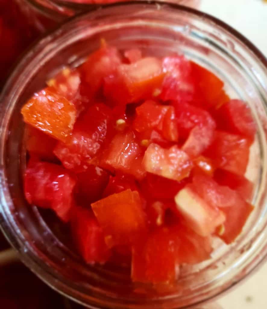 jar filled with diced tomatoes from the top of the jar