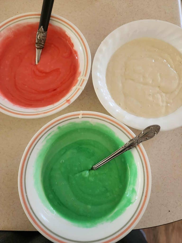 3 bowls of cake batter, red, green and white to make colorful Christmas Bundt cake