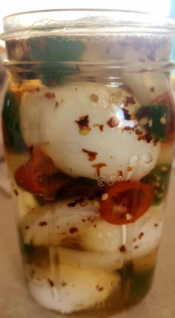 sweet and spicy pickled eggs in jar