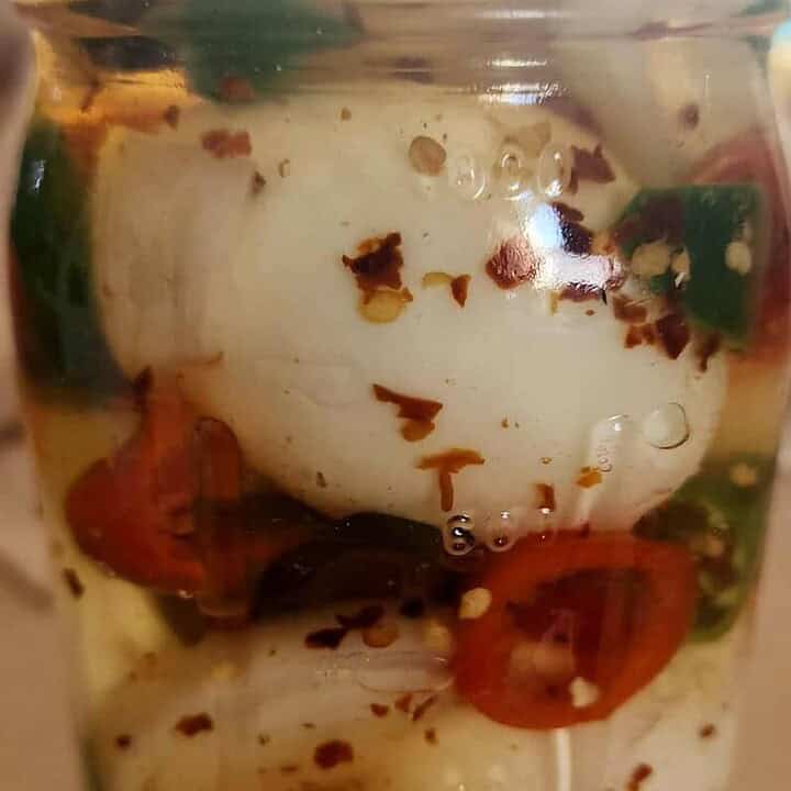 sweet and spicy pickled eggs in jar