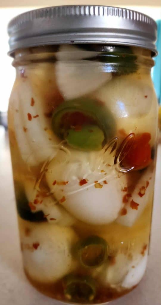 sweet and spicy pickled eggs in jar