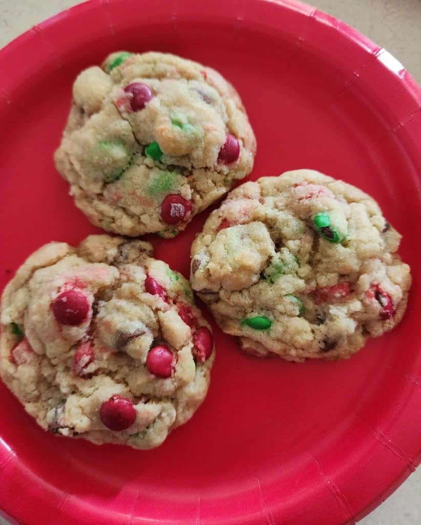 3 Christmas Cookies in a jar after baking on a red plate
