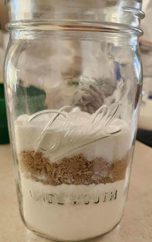 Sugars and flour, salt etc added to jar for Christmas Cookies in a Jar