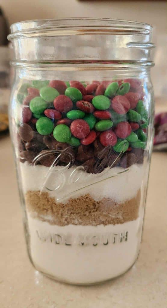 Added the chocolate chips and m&ms for Christmas cookies in a jar