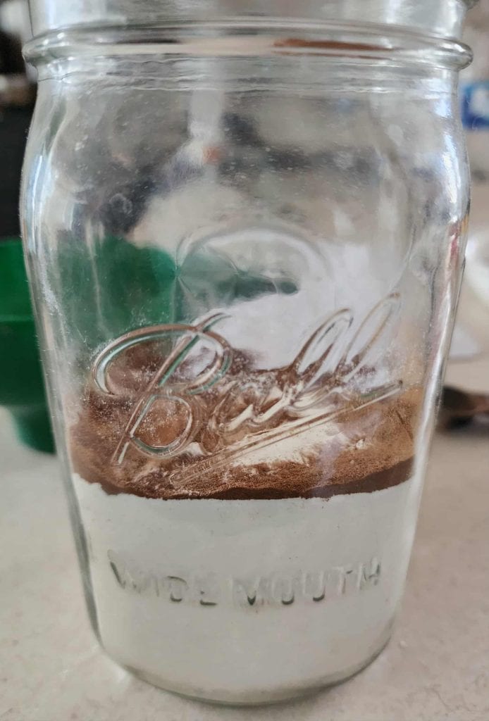 Cinnamon layered towards the outside of the jar to make Christmas Muffins in a jar