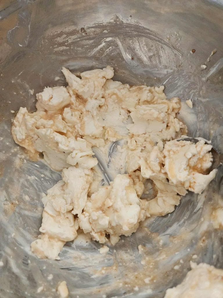 Mixing the cream cheese and Italian dressing for salami pickle roll ups