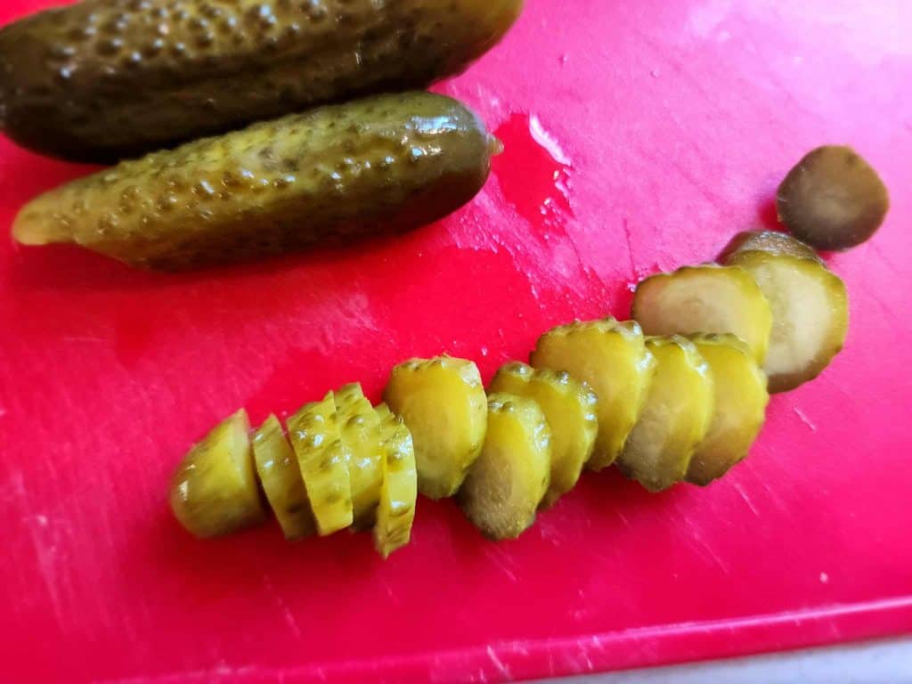 slicing baby dill pickles
