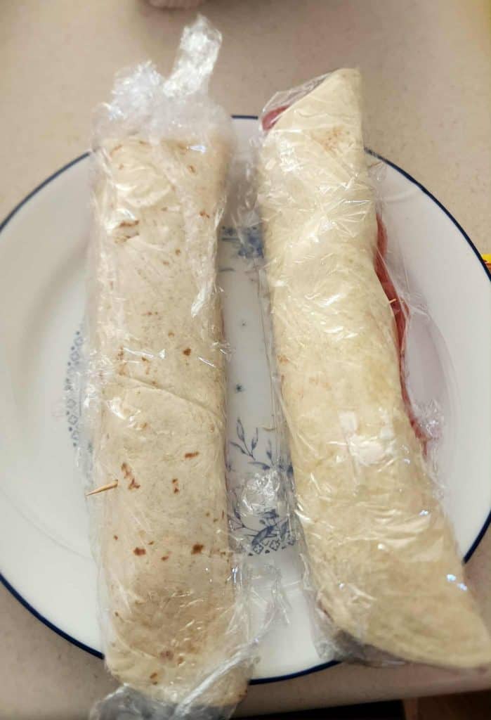 tortillas wrapped in plastic to make salami pickle roll ups