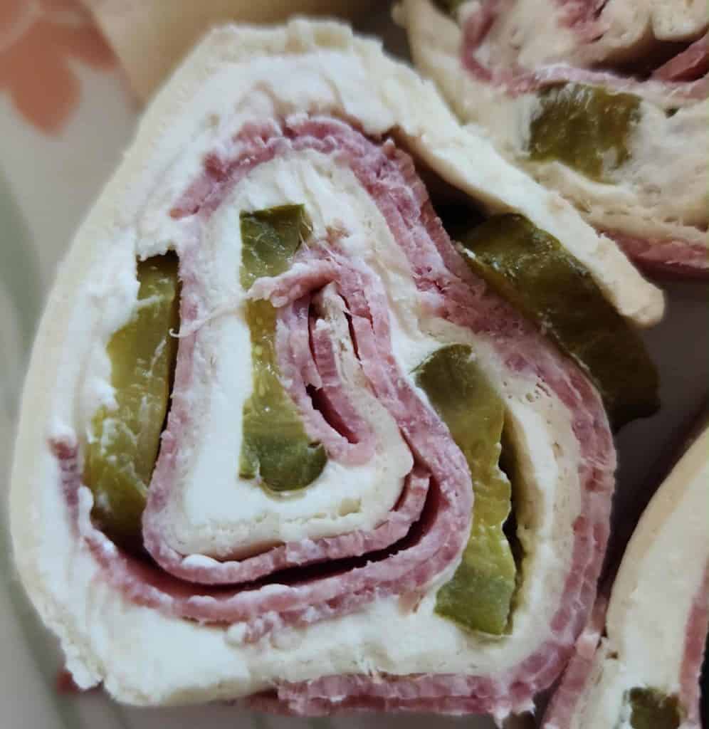 Close up of salami pickle roll up
