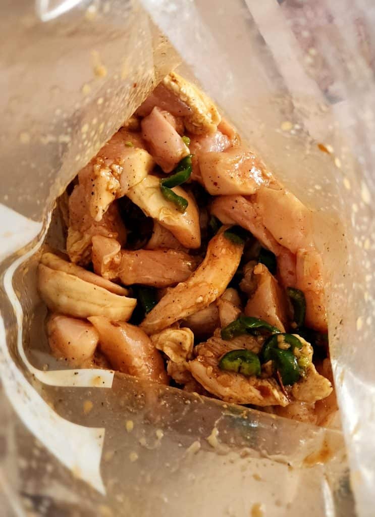 top of bag of chicken in fajita marinade