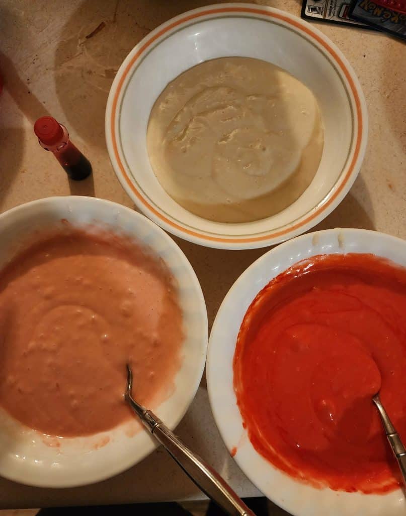 3 bowls of cake mix with colors