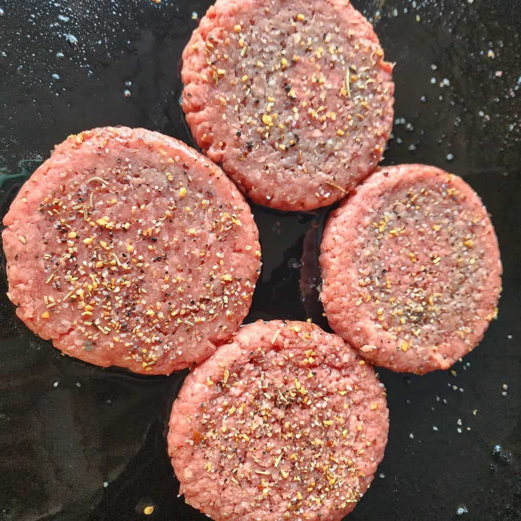 seasoning sprinkled on burgers